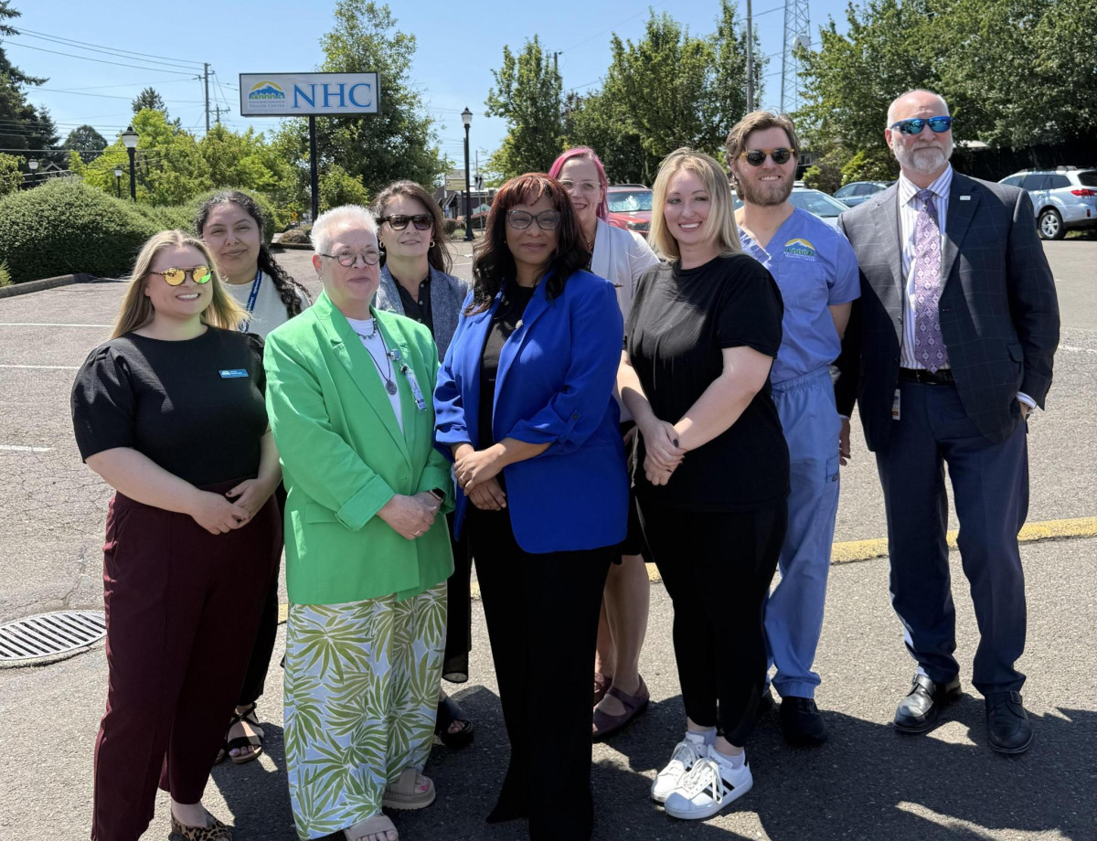 Congresswoman Janelle Bynum stands with healthcare professionals from Neighborhood Health Center.