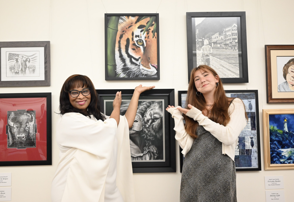 Congresswoman Bynum stands with Congressional Art Competition winner Ren Suo next to Ren's painting of a tiger.