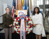 Congresswoman Bynum presenting a service member with a wreath at a wreath laying ceremony at the Arlington National Cemetery.