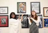 Congresswoman Bynum stands with Congressional Art Competition winner Ren Suo next to Ren's painting of a tiger. 