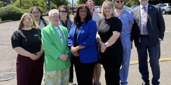 Congresswoman Janelle Bynum stands with healthcare professionals from Neighborhood Health Center.